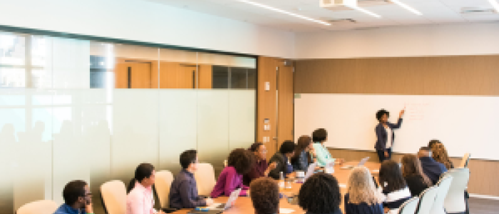 A group of people seated around a conference table